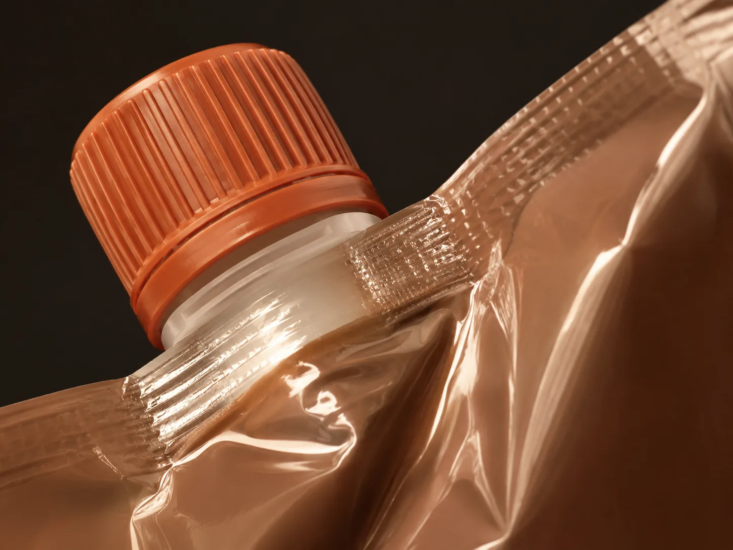 Welded corner spout with ribbed cap on a glossy refill pouch — Sparal Packaging structural detail