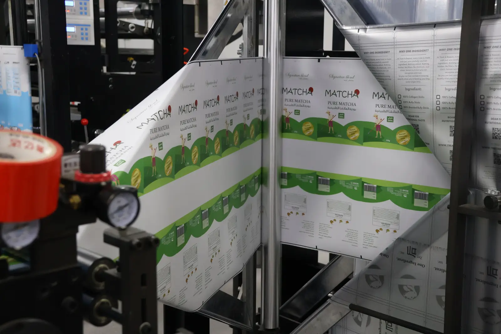 Printed flexible packaging film running through production equipment